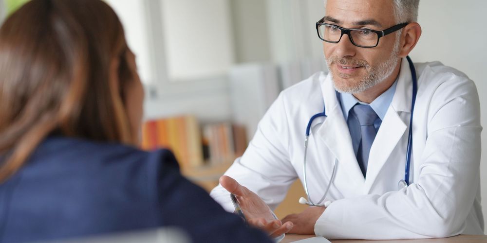 Ein Arzt berät eine Patientin zur Behandlung von Leukämie. 