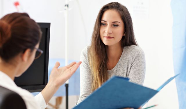 Eine Ärztin informiert eine Frau darüber, was eine Gebärmuttersenkung ist.