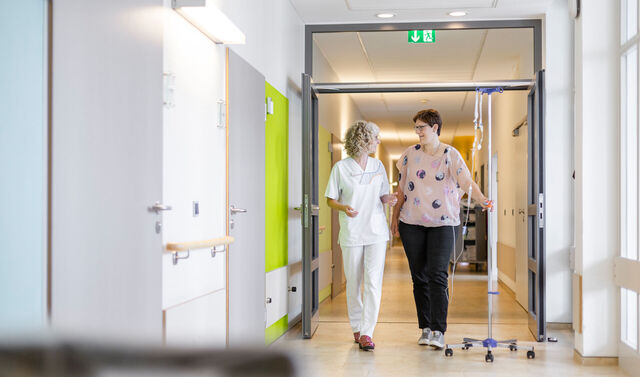 Eine Mitarbeiterin der Gynäkologie betreut eine Patientin auf der onkologischen Station.